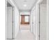 The hallway features neutral carpeting and leads to a room with paneled walls and a window at 1544 Overview Cir, Lawrenceville, GA 30044