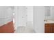Hallway leading to the bathroom, showing neutral carpet and access to other rooms at 1544 Overview Cir, Lawrenceville, GA 30044