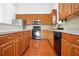 Spacious kitchen featuring wood cabinets, a breakfast bar, and stainless steel appliances at 1544 Overview Cir, Lawrenceville, GA 30044