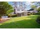 Manicured backyard with covered patio and mature landscaping provides a private outdoor oasis at 3407 Larch Pine Dr, Duluth, GA 30096