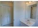 Bright bathroom with a large mirror, vanity, and louvered closet doors at 3407 Larch Pine Dr, Duluth, GA 30096
