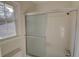 Bathroom shower with glass doors and white tiled walls is bright and clean at 3407 Larch Pine Dr, Duluth, GA 30096