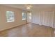 Bedroom featuring laminate flooring, natural light and double closets at 3407 Larch Pine Dr, Duluth, GA 30096