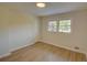 Bedroom with light wood floors, two windows for natural light, and neutral walls at 3407 Larch Pine Dr, Duluth, GA 30096