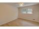 Bedroom with ceiling fan, two windows for natural light, and light wood floors at 3407 Larch Pine Dr, Duluth, GA 30096