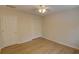 Bedroom with ceiling fan, bi-fold closet doors, and light wood floors at 3407 Larch Pine Dr, Duluth, GA 30096