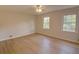Spacious bedroom featuring two windows and laminate flooring at 3407 Larch Pine Dr, Duluth, GA 30096