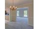 Traditional dining room showcasing chandelier and views to open concept living area at 3407 Larch Pine Dr, Duluth, GA 30096