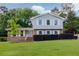Charming two-story home with light siding, a brick foundation and well-manicured landscaping at 3407 Larch Pine Dr, Duluth, GA 30096