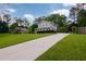 View of the home with a long driveway and large front lawn at 3407 Larch Pine Dr, Duluth, GA 30096
