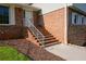 Brick staircase leading to the front door with light-colored trim and well-maintained landscape at 3407 Larch Pine Dr, Duluth, GA 30096