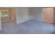 Open living area with carpet flooring and multiple access points to other rooms at 3407 Larch Pine Dr, Duluth, GA 30096