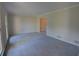 Spacious living room with light walls, neutral carpet, and a doorway to another room at 3407 Larch Pine Dr, Duluth, GA 30096