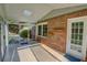 Bright sunroom featuring brick walls, tiled floor, windows and access to private backyard at 3407 Larch Pine Dr, Duluth, GA 30096