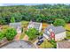 Residential aerial view showcasing multiple homes with tree lined yards in a quiet neighborhood at 408 Sam Cobb Ct, Woodstock, GA 30188