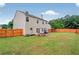 Spacious fenced backyard with a well-maintained lawn and patio area for outdoor enjoyment at 408 Sam Cobb Ct, Woodstock, GA 30188