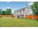 Expansive backyard featuring a lush lawn, privacy fence, and outdoor seating area at 408 Sam Cobb Ct, Woodstock, GA 30188