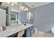 Bathroom featuring a modern vanity with a white countertop and updated fixtures, with light blue walls at 408 Sam Cobb Ct, Woodstock, GA 30188