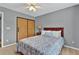 Bedroom showcasing a bed with gray patterned cover and a closet with sliding wood doors at 408 Sam Cobb Ct, Woodstock, GA 30188