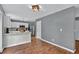 Spacious dining area adjacent to the kitchen featuring hardwood floors and contemporary lighting at 408 Sam Cobb Ct, Woodstock, GA 30188