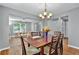 Dining room with hardwood floors, chandelier, and view of the living room at 408 Sam Cobb Ct, Woodstock, GA 30188