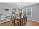 Dining room with hardwood floors, traditional chandelier, and large windows at 408 Sam Cobb Ct, Woodstock, GA 30188