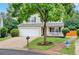 Charming two-story home with a well-manicured lawn, a covered front porch, and attached garage at 408 Sam Cobb Ct, Woodstock, GA 30188