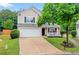 Charming two-story home with a well-manicured lawn and inviting front porch at 408 Sam Cobb Ct, Woodstock, GA 30188