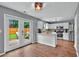 Open-concept kitchen with stainless steel appliances and a view of the backyard patio through glass doors at 408 Sam Cobb Ct, Woodstock, GA 30188