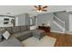 Open-concept living room with hardwood floors, a staircase, and a view into the adjacent kitchen at 408 Sam Cobb Ct, Woodstock, GA 30188