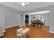 Open concept living room with hardwood floors, gray walls, and adjacent dining area at 408 Sam Cobb Ct, Woodstock, GA 30188