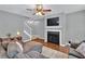 Comfortable living room with a fireplace, TV, ceiling fan and a staircase to the upper level at 408 Sam Cobb Ct, Woodstock, GA 30188