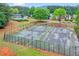 Outdoor tennis courts surrounded by trees enhance the community's recreational offerings at 408 Sam Cobb Ct, Woodstock, GA 30188