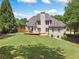 Spacious backyard with large lawn, a deck, and mature trees providing shade and privacy at 6209 Benbrooke Dr, Acworth, GA 30101