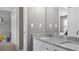 Bathroom with a granite countertop double vanity, with a mirror, a closet, and a door leading to a bedroom at 6209 Benbrooke Dr, Acworth, GA 30101