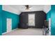 Spacious bedroom with dark accent wall, bright blue walls, and plenty of natural light at 6209 Benbrooke Dr, Acworth, GA 30101