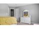 Bedroom features a comfortable bed with a yellow comforter and a matching dresser with a mirror at 6209 Benbrooke Dr, Acworth, GA 30101