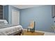 Bedroom with blue walls and a chair is perfect for guests or  at 6209 Benbrooke Dr, Acworth, GA 30101