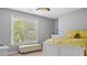 Sunny bedroom featuring a window, light-colored walls, and a white bed with yellow bedding at 6209 Benbrooke Dr, Acworth, GA 30101