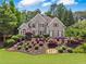Charming two-story home with lush landscaping and a well-manicured front yard at 6209 Benbrooke Dr, Acworth, GA 30101