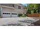Attached two-car garage with an expansive paved driveway and mature landscaping at 6209 Benbrooke Dr, Acworth, GA 30101