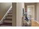 Hallway with a staircase leading to the upper level, offering easy access to different parts of the home at 6209 Benbrooke Dr, Acworth, GA 30101