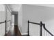 Hallway with hardwood floors, white trim, and modern gray paint at 6209 Benbrooke Dr, Acworth, GA 30101