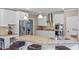 Bright kitchen boasts granite countertops, stainless steel appliances, island with seating, and white cabinets at 6209 Benbrooke Dr, Acworth, GA 30101