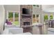 Cozy living room with stone fireplace, large windows, and hardwood floors, creating a warm and inviting atmosphere at 6209 Benbrooke Dr, Acworth, GA 30101