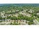 Serene aerial view of a meticulously planned neighborhood surrounded by lush trees and verdant landscapes at 1647 Tunbridge Ln, Lawrenceville, GA 30043