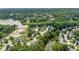 Aerial view of lakeside homes surrounded by lush trees, offering a serene neighborhood setting at 1647 Tunbridge Ln, Lawrenceville, GA 30043