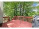 A cozy back deck with lush foliage, perfect for outdoor entertaining and relaxation at 1647 Tunbridge Ln, Lawrenceville, GA 30043