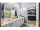 Bathroom featuring a double vanity with framed mirrors and tiled floors at 1647 Tunbridge Ln, Lawrenceville, GA 30043