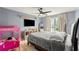 Comfortable bedroom with a ceiling fan, large window, and tile flooring, blending style and practicality at 1647 Tunbridge Ln, Lawrenceville, GA 30043